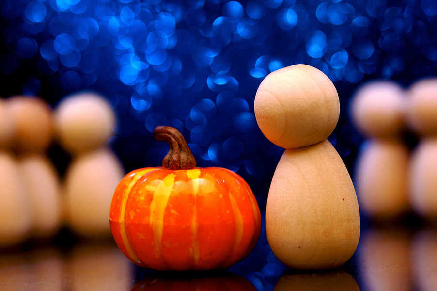 Photo of a generic person looking at a pumpkin