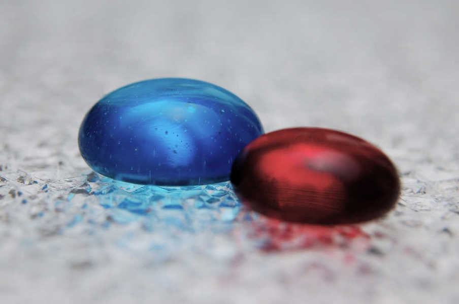 Photo of two glass tokens resembling the Flickr logo on artificial ice