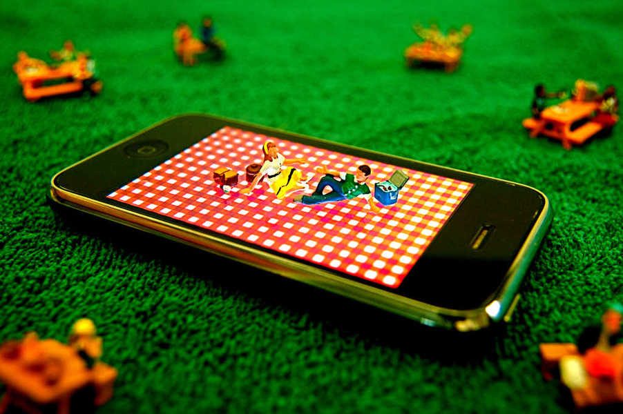 Photo of two small people having a picnic on an iPhone