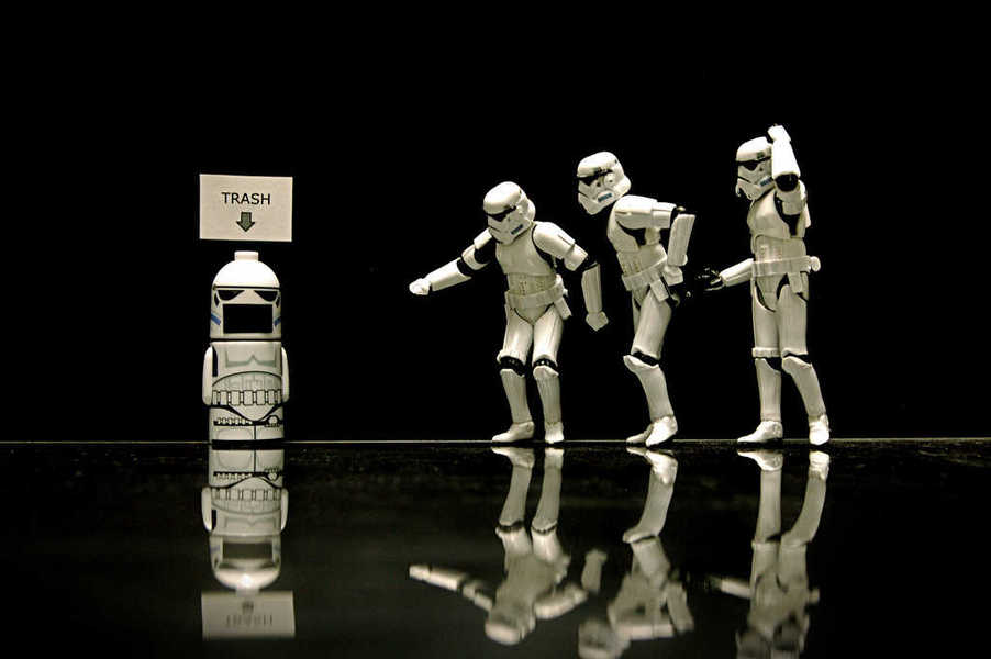 Photo of several stormtroopers approaching a stormtrooper-themed trash can